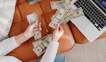 Close-up of Woman Counting Dollar Bills