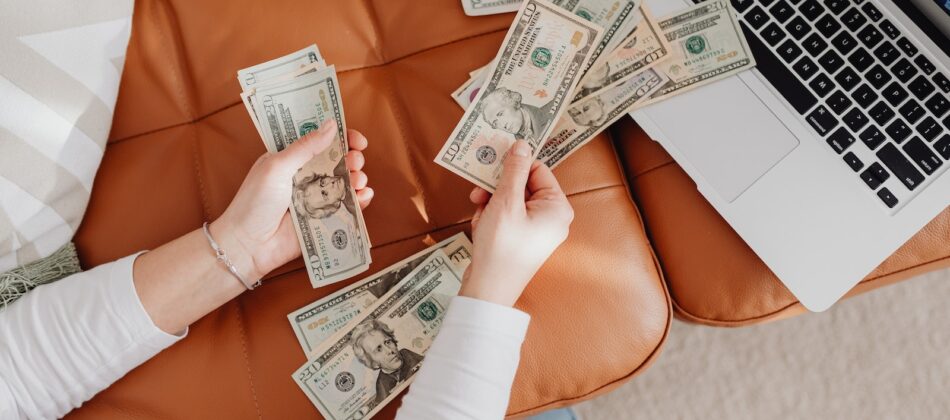 Close-up of Woman Counting Dollar Bills